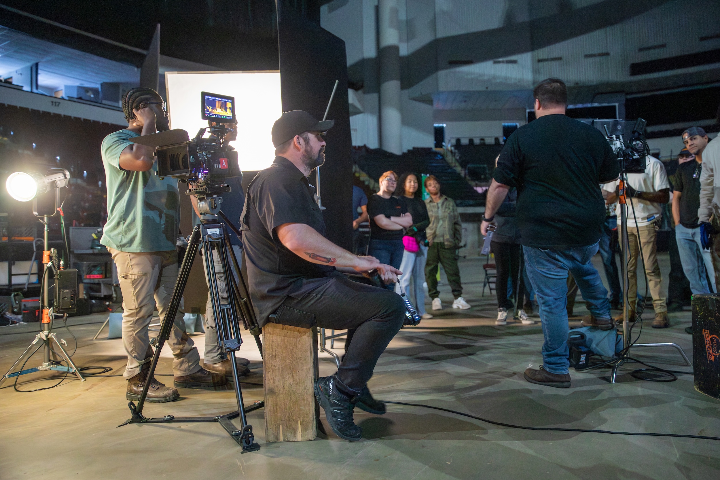 A film crew on set with lights and camera.